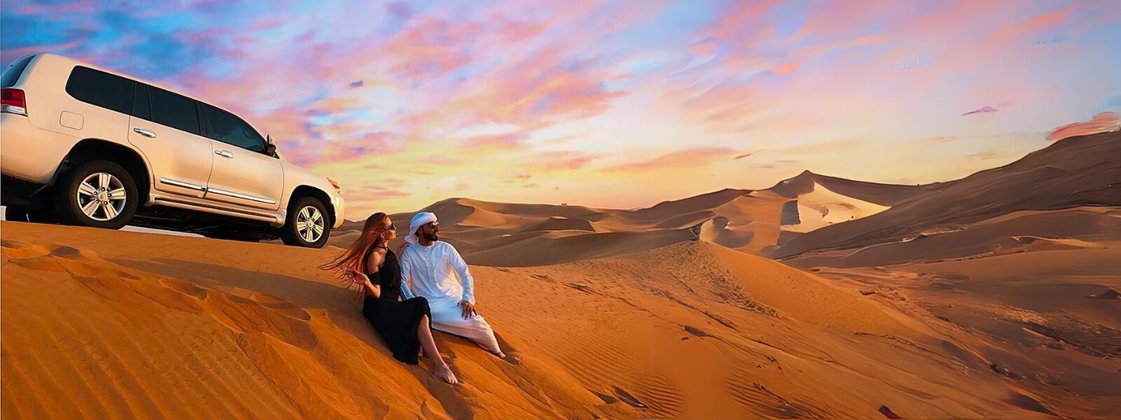Man and woman chilling in the desert and a car in the background allures the look