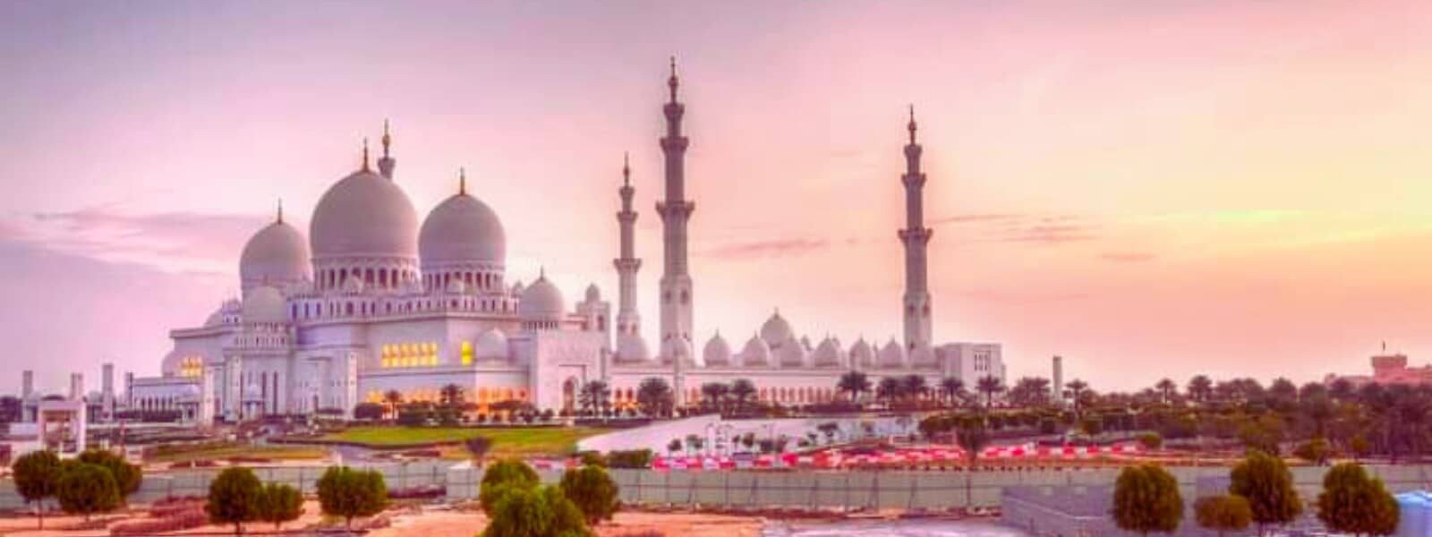 The majestic Grand Mosque in Abu Dhabi, showcasing intricate Islamic architecture and stunning white domes.