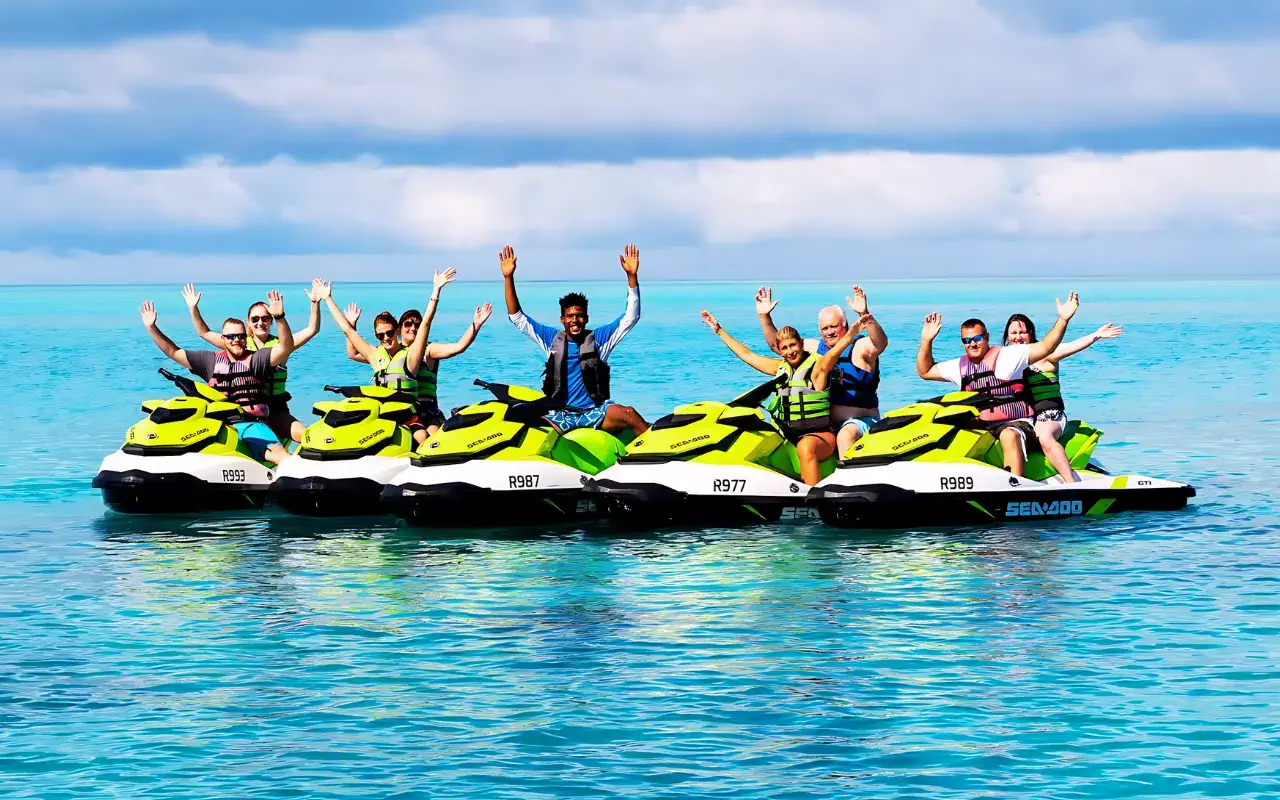A group of people riding jet skis in the ocean, enjoying the thrill of the water sport.